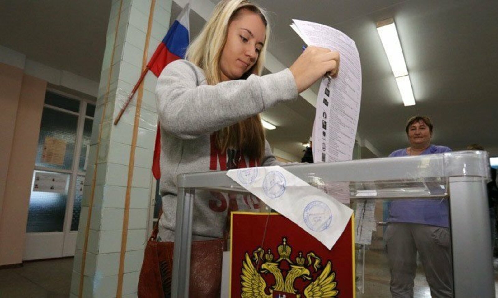 Проголосовал на выборах президента россии гражданин. Люди голосуют. Люди голосуют на выборах. Голосует на выборах. Голосование на избирательном участке.